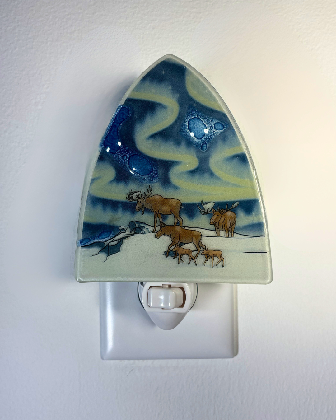 Decorative night light with a moose family design on a blue and yellow background