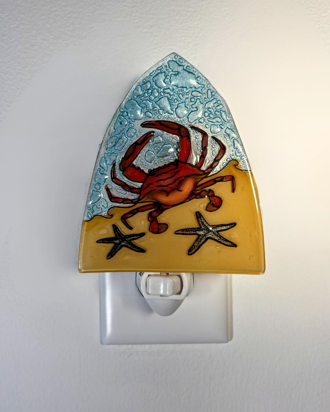Decorative night light with a crab and starfish design on a white background