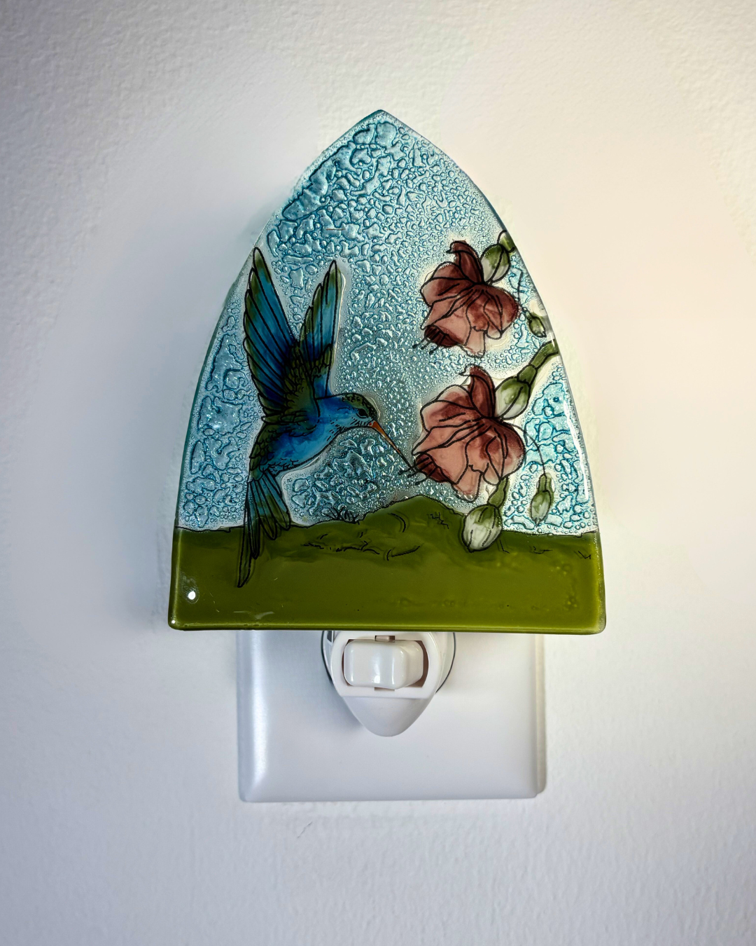 Decorative night light with a hummingbird and floral design on a white background