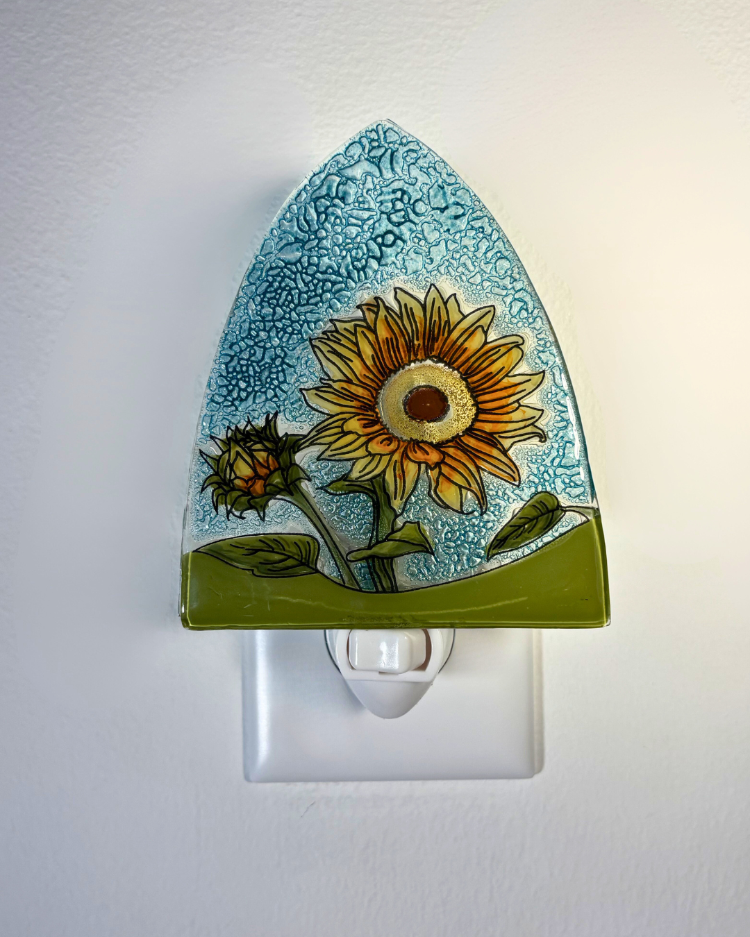 Decorative night light with sunflower design on a white background