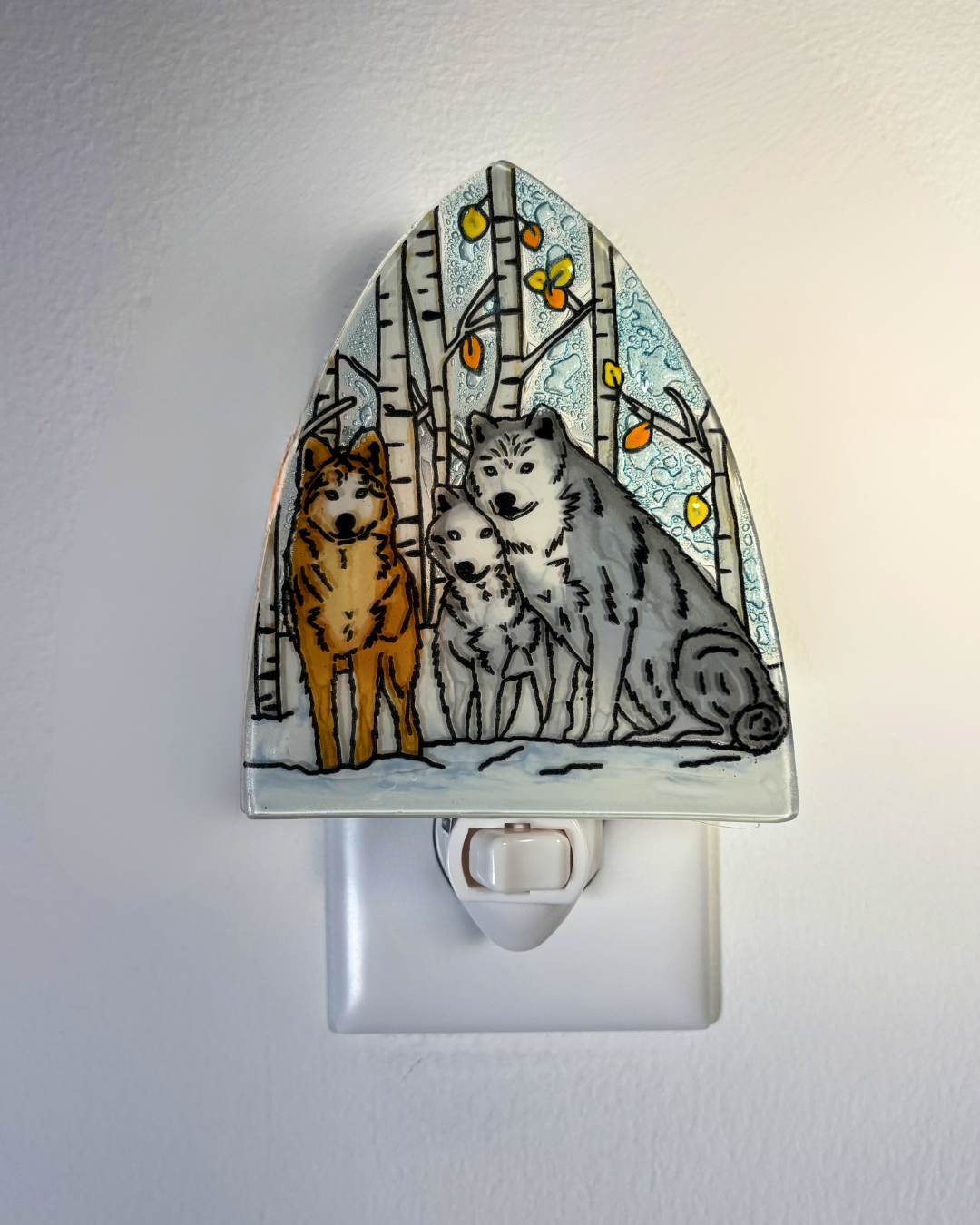 Decorative night light with wolves and birch trees design on a white background