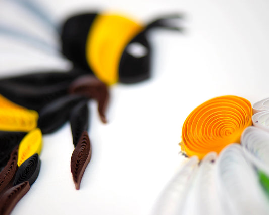 Close Up of Greeting Card with green envelope with a quilled bumble bee slowly approaching a white daisy.