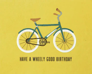 A birthday card with an illustration of a blue bicycle on a yellow background, with the text 'HAVE A WHEELY GOOD BIRTHDAY'.