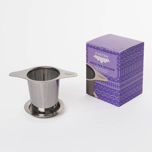 Stainless steel mesh tea infuser with purple Justea packaging on a white background