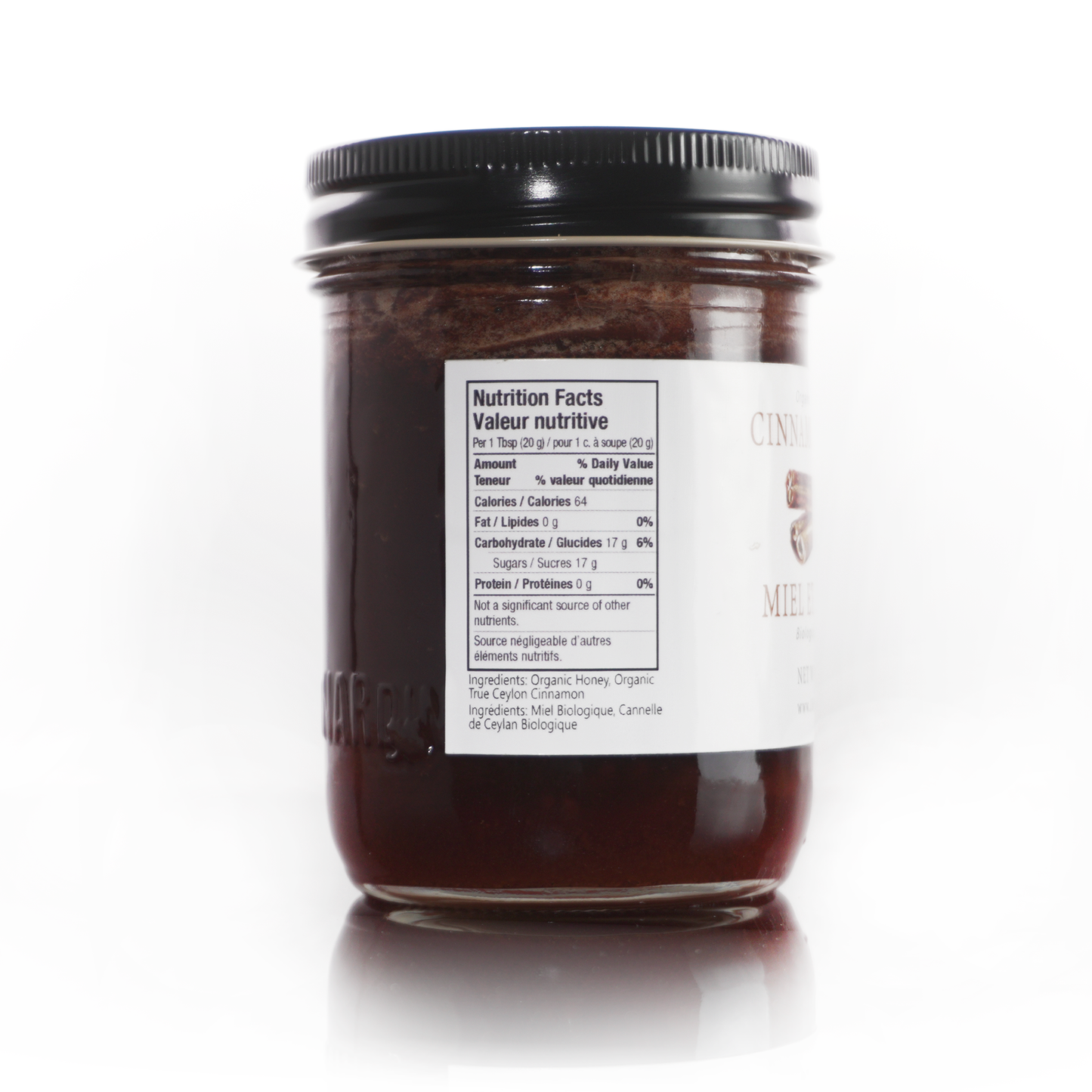 Jar of cinnamon honey with nutrition information label on a white background