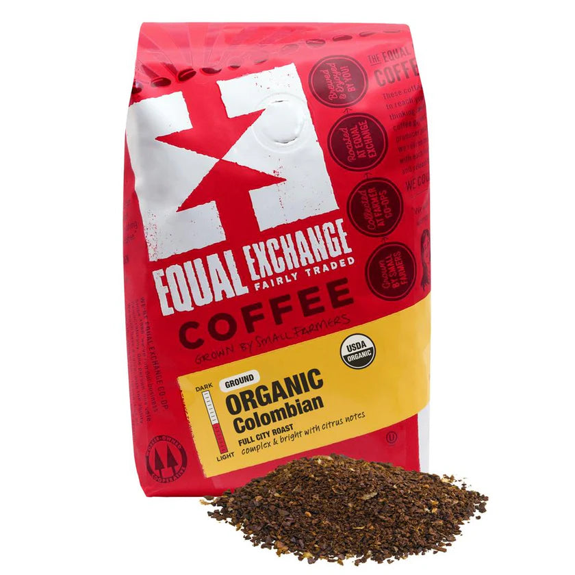 Red bag of Equal Exchange Organic Colombian coffee with ground coffee in front