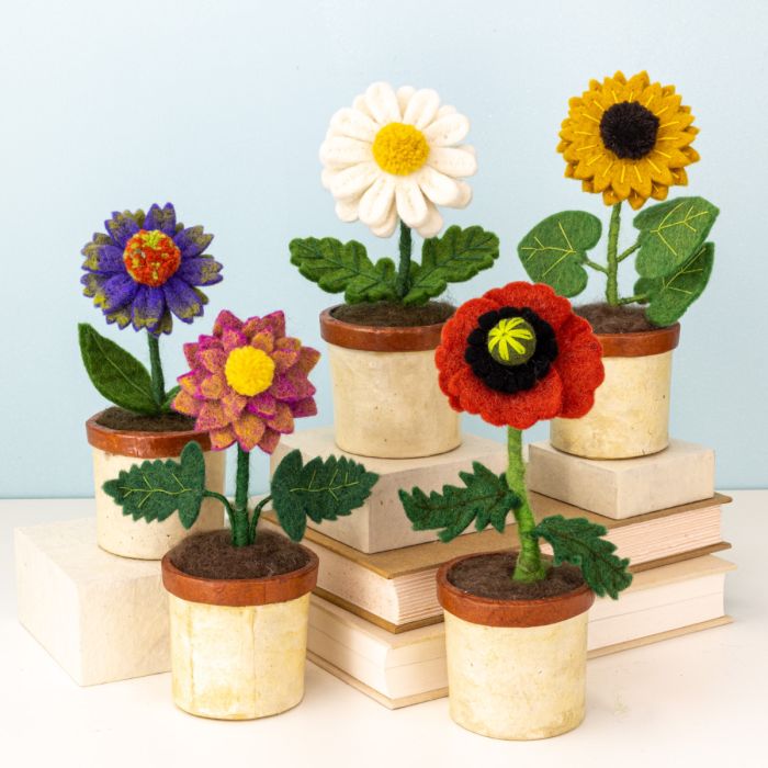 Colorful felt flower pots on a light blue background