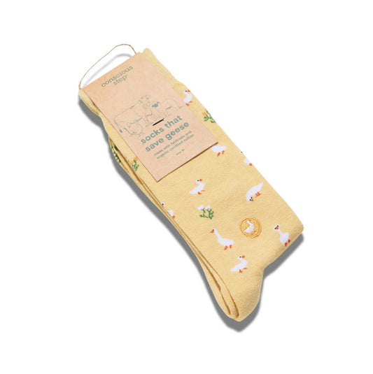 Yellow socks with duck pattern and packaging on a white background