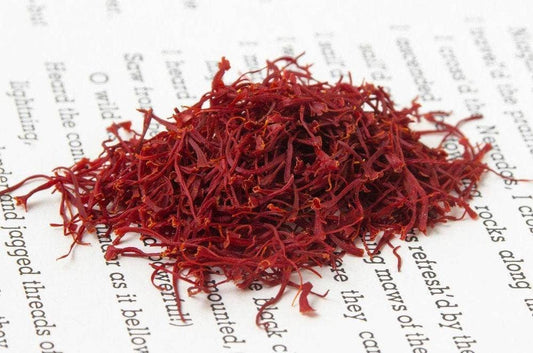 Red dried herbs on a piece of paper with text
