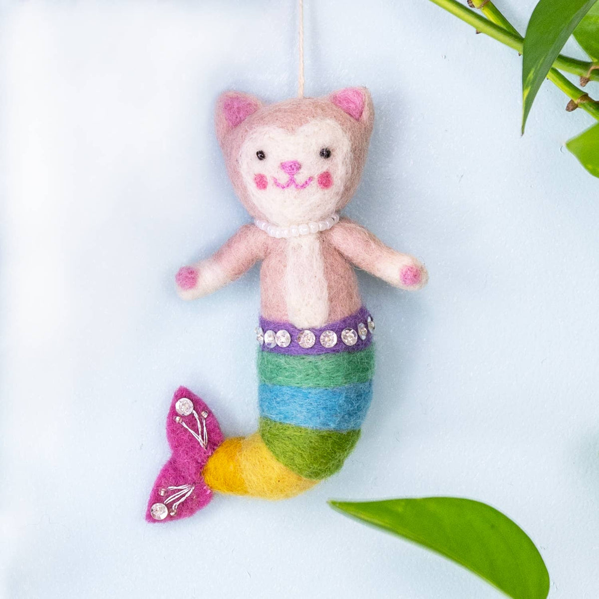 Felt mermaid cat toy with a colorful tail on a light blue background