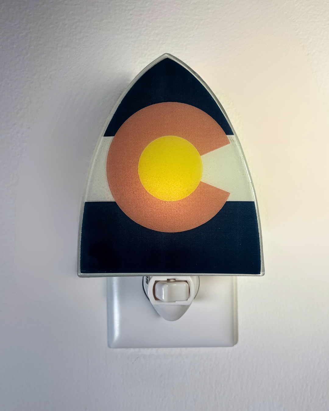 Night light with Colorado flag design on a white wall