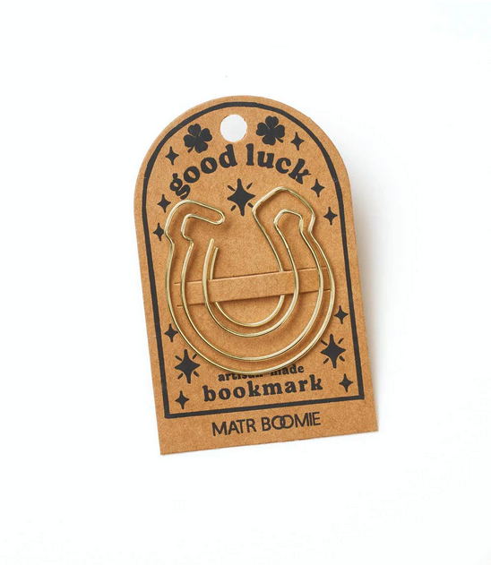 Gold wire horseshoe-shaped bookmark attached to cardstock with the words "good luck"