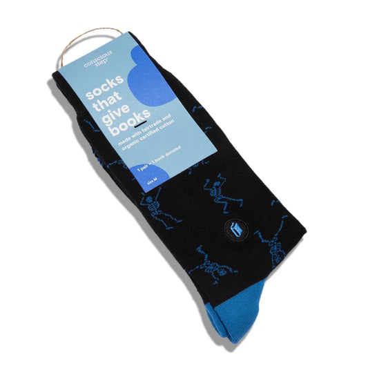 Black sock with small blue dancing skeletons in a light blue packaging with white text