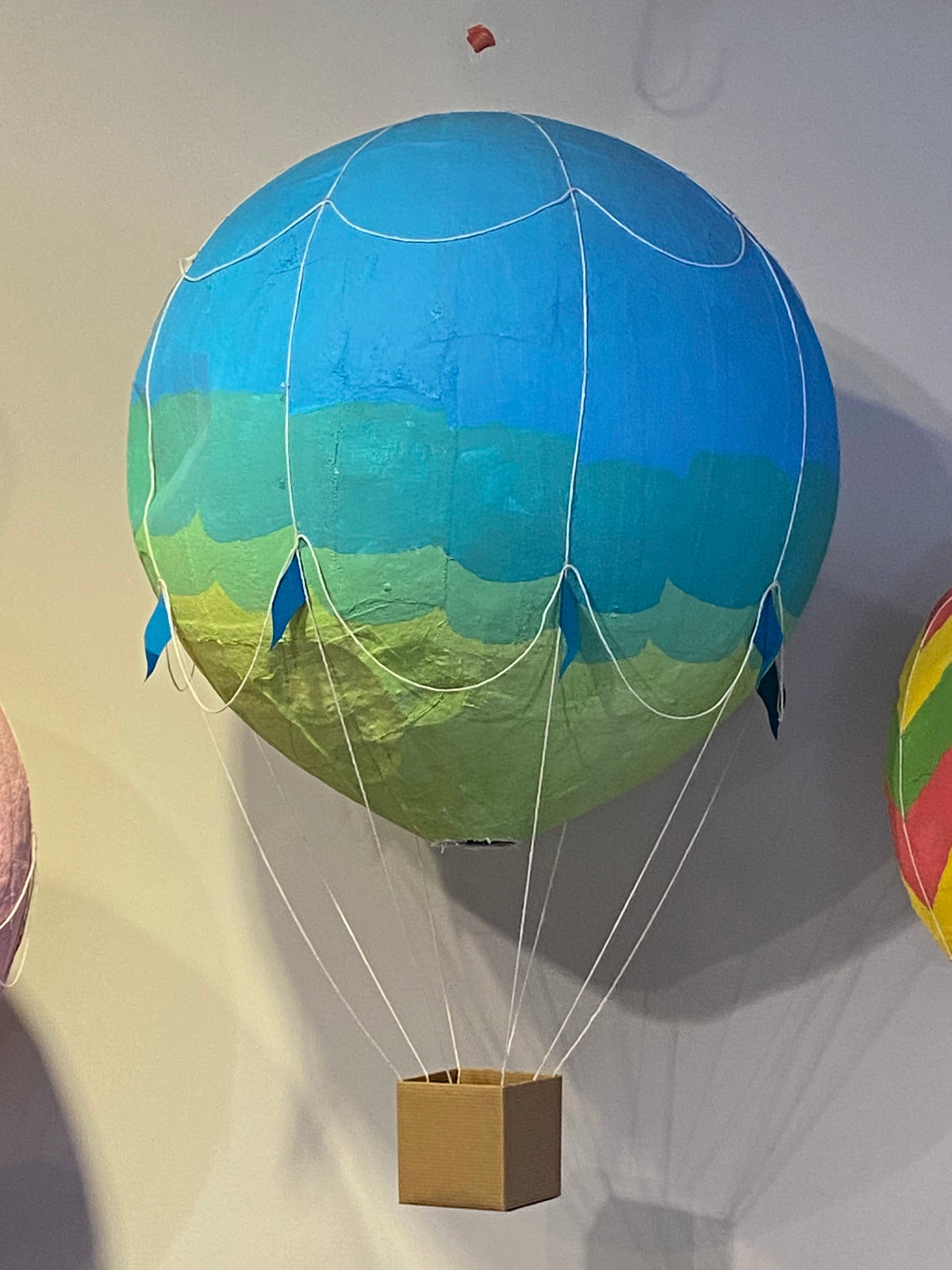 Blue, teal, and green plaster of paris hot air balloon.