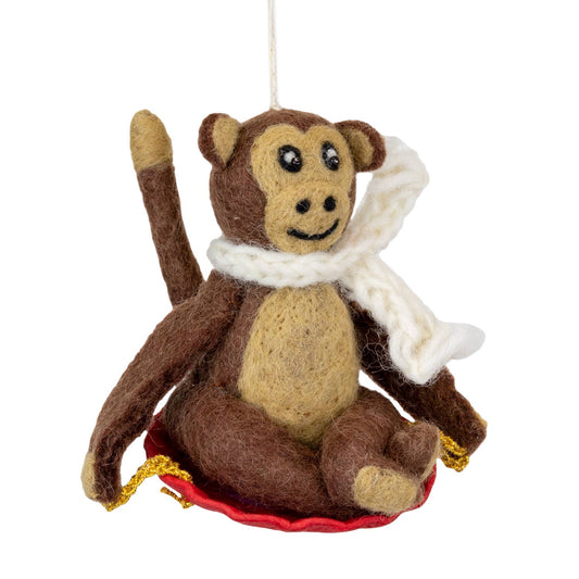 Felted monkey ornament with a white scarf on a white background