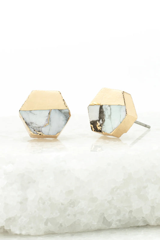 Hexagonal earrings with gold and marble design on a white background