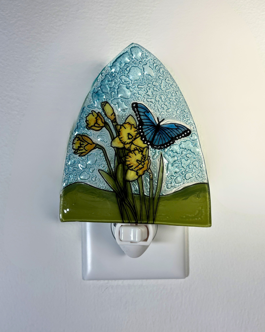 Decorative night light with floral and butterfly design on a white background