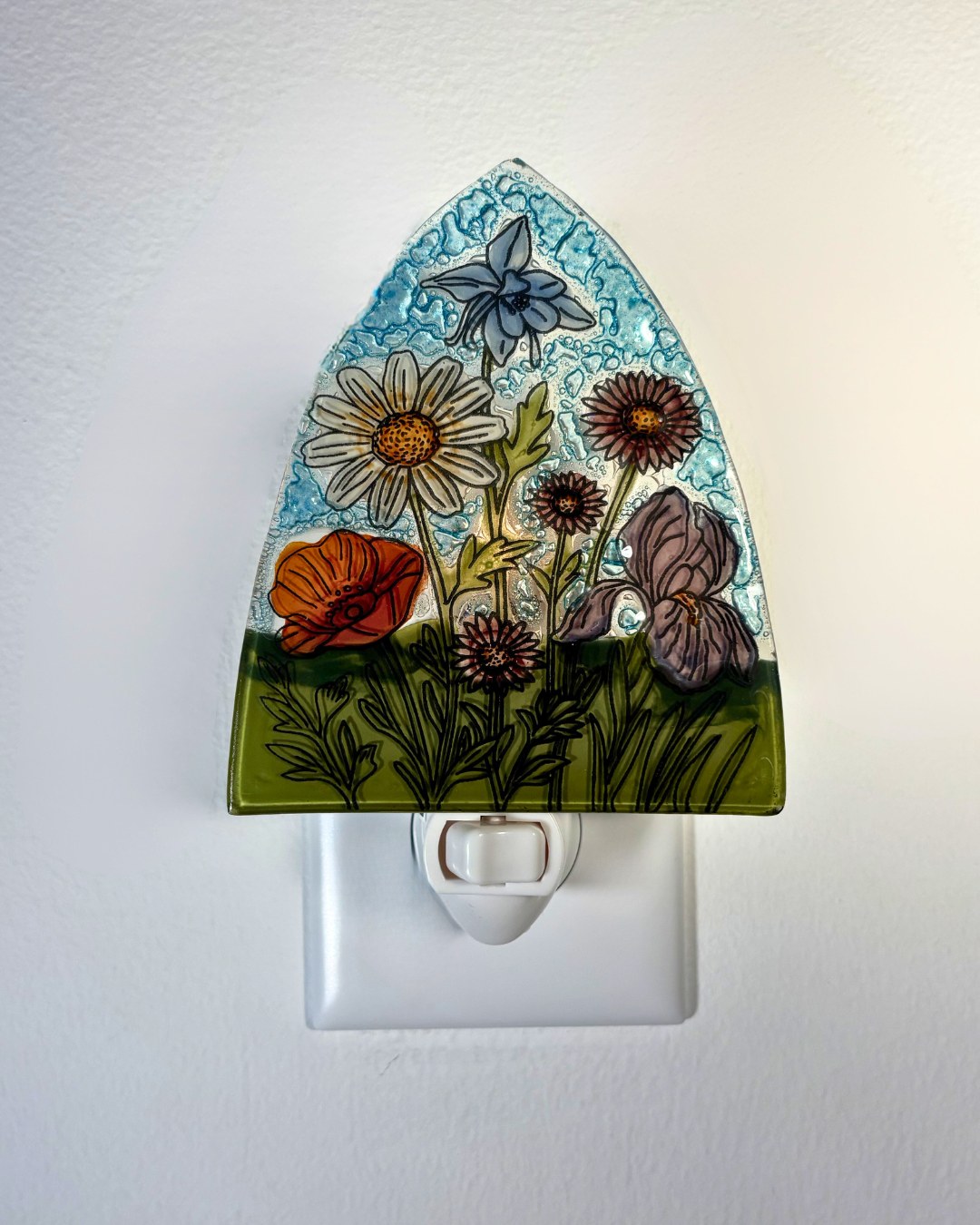 Decorative night light with floral design on a white background