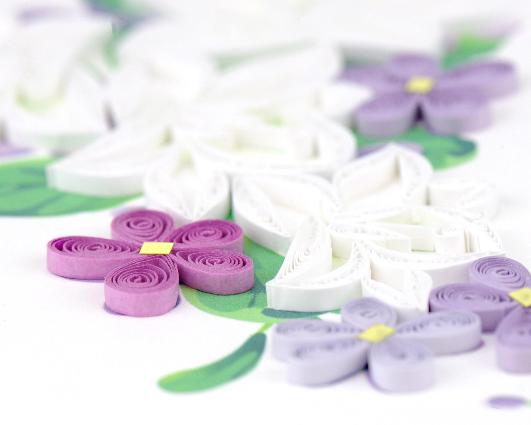 Floral card with white lilies and purple flowers on a white background