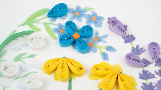 Close Up of Card with a heart-shaped arrangement of colorful flowers on a white background