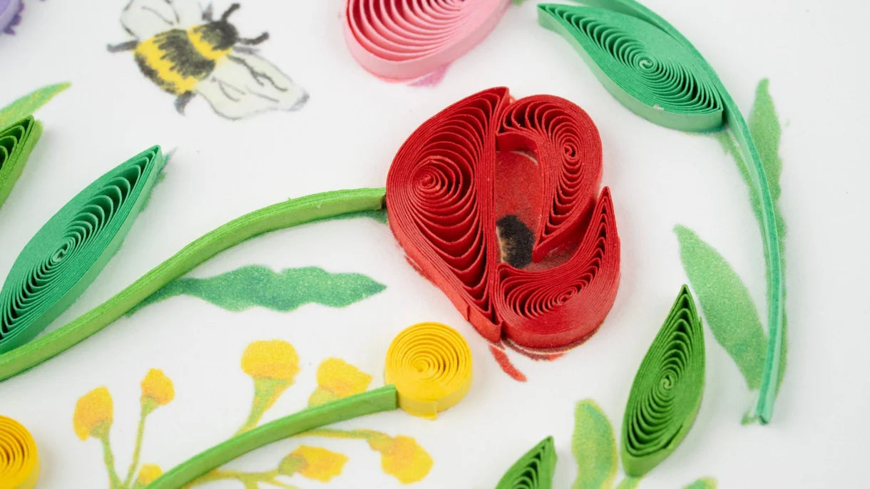 Close Up of Card with a heart-shaped arrangement of colorful flowers on a white background