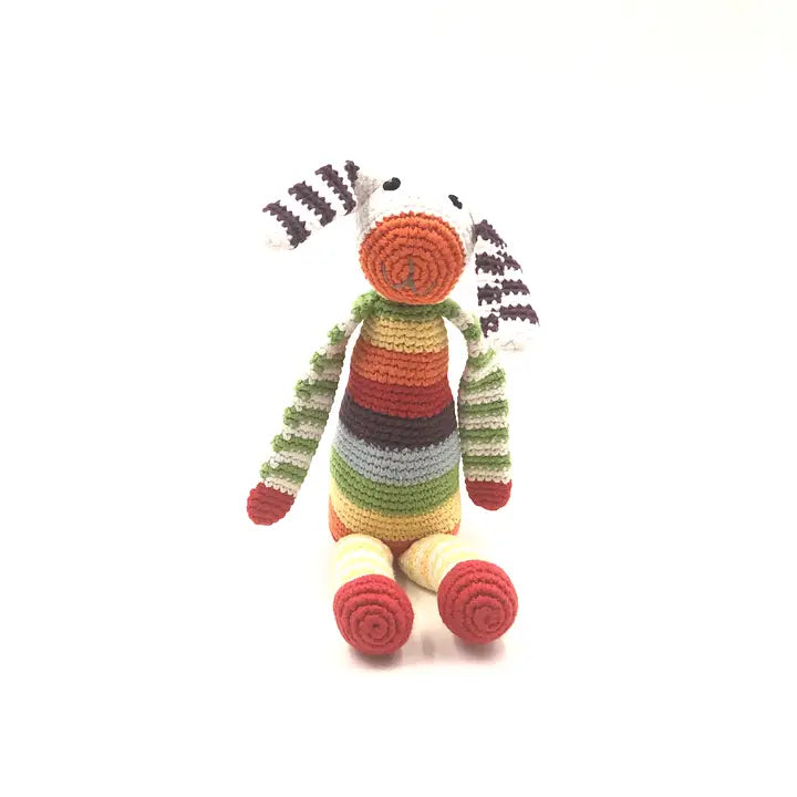 A colorful plush toy resembling a bunny with a striped pattern on its head and body, primarily in red, green, yellow, and blue hues. 
