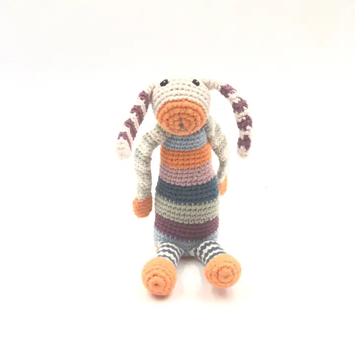 A multicolor striped plush toy resembling a bunny with a velvety texture, featuring orange feet and a striped body.