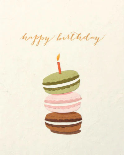 Illustration of macaron cookies with a candle on a light background with 'happy birthday' text.