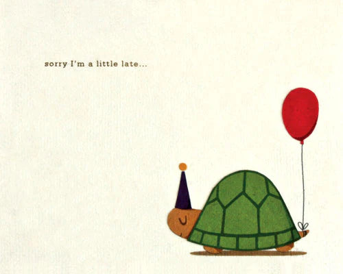 A greeting card with an illustration of a turtle wearing a party hat and holding a red balloon, with the text 'sorry I'm a little late.
