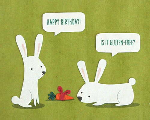 A birthday card with a green background featuring cartoon rabbits. One rabbit is asking 'HAPPY BIRTHDAY!' and the other rabbit is asking 'IS IT GLUTEN-FREE?'.