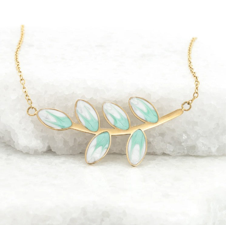 Gold necklace with mint green leaf-shaped design on a white background