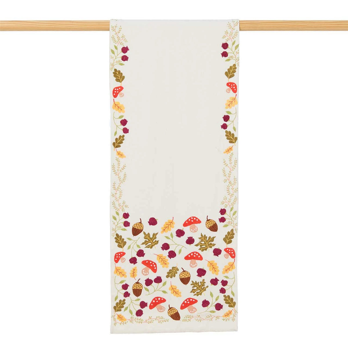 Cream-colored cotton table runner with hand-embroidered autumn leaves, Indian poppies and red-and-white mushrooms.