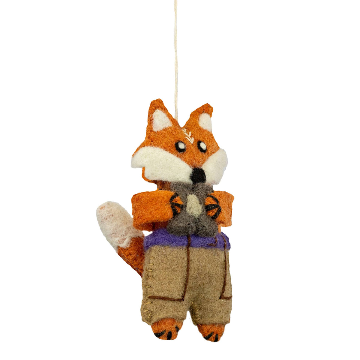 A felted wool fox ornament wearing a tan pants and holding a pair of binoculars suspended by a white string against a plain white background.