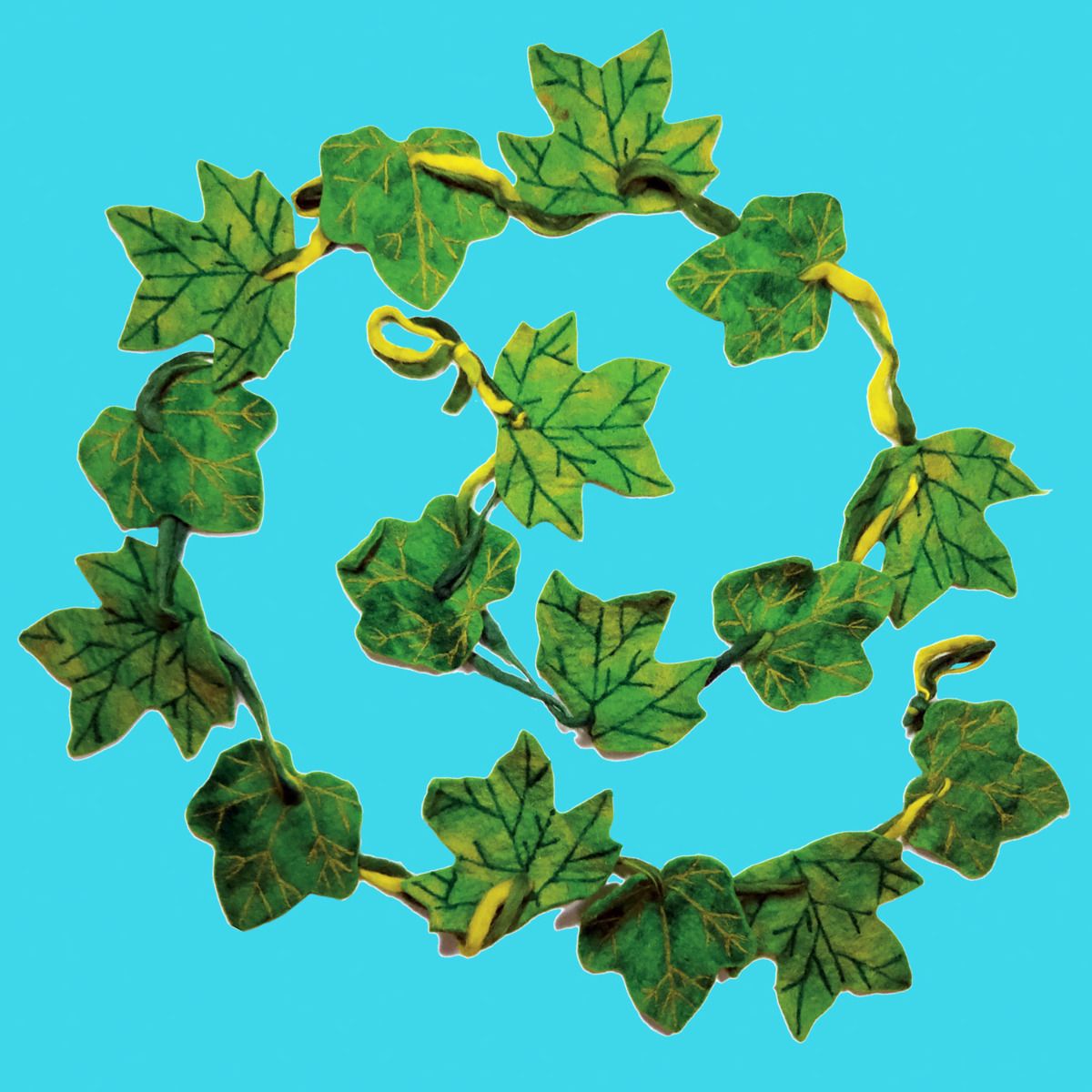 Green felted leaf garland on a blue background