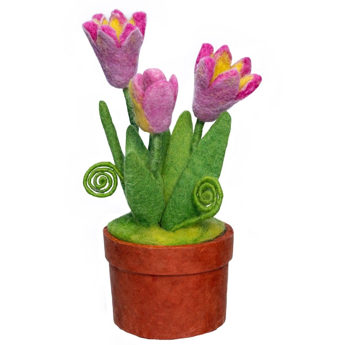 Three felted pink tulips in a terracotta colored pot on a white background