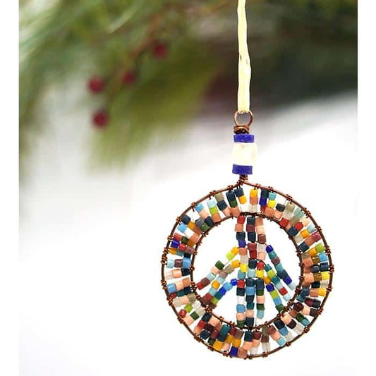 A peace sign shaped rainbow beaded ornament made from recycled glass.