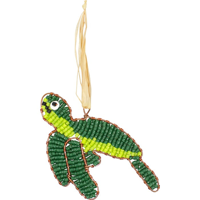 A green sea turtle shaped ornament made with glass beads and wire hanging by a piece of raffia.
