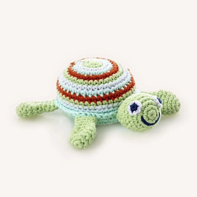 Crocheted turtle toy with striped shell on a white background