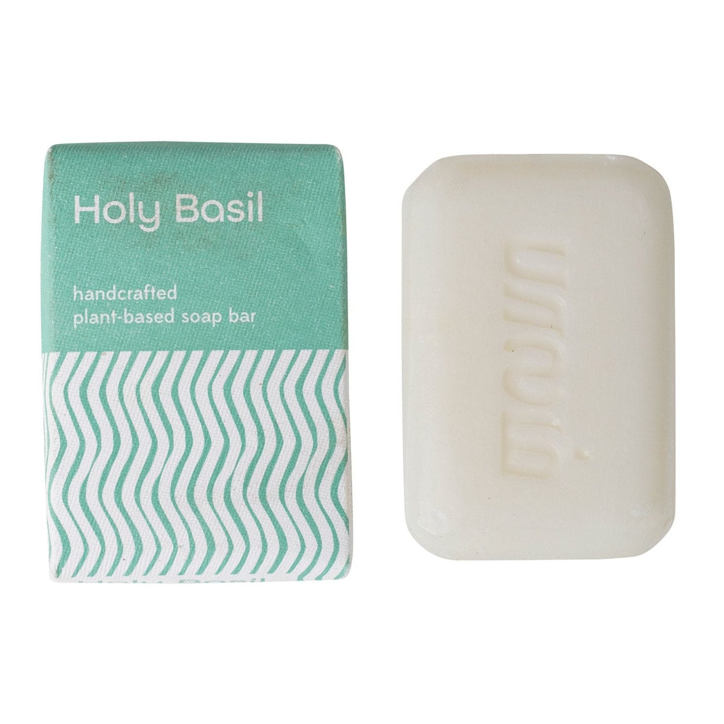 A bar of soap with 'Holy Basil' text on the packaging, is placed on a white background.