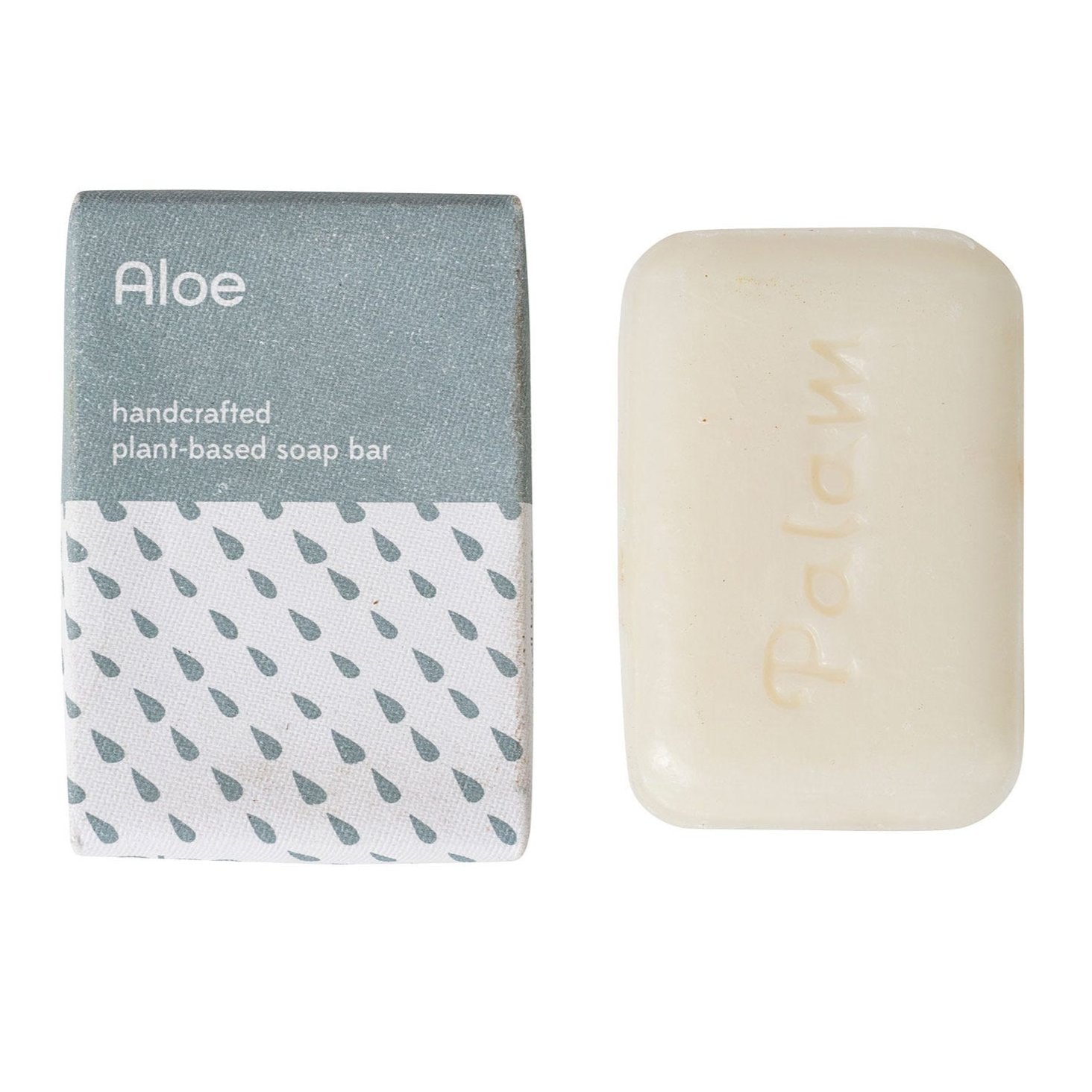 A gray and white handcrafted soap bar with the brand name 'PALAM' inscribed on it, next to its packaging that has a geometric design and the word 'ALOE' prominently displayed.