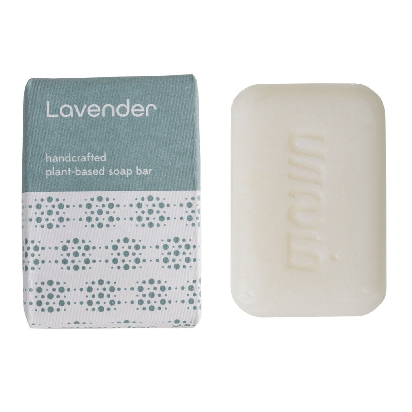 A bar of lavender handcrafted soap next to its packaging, which has a geometric pattern in shades of blue and white.