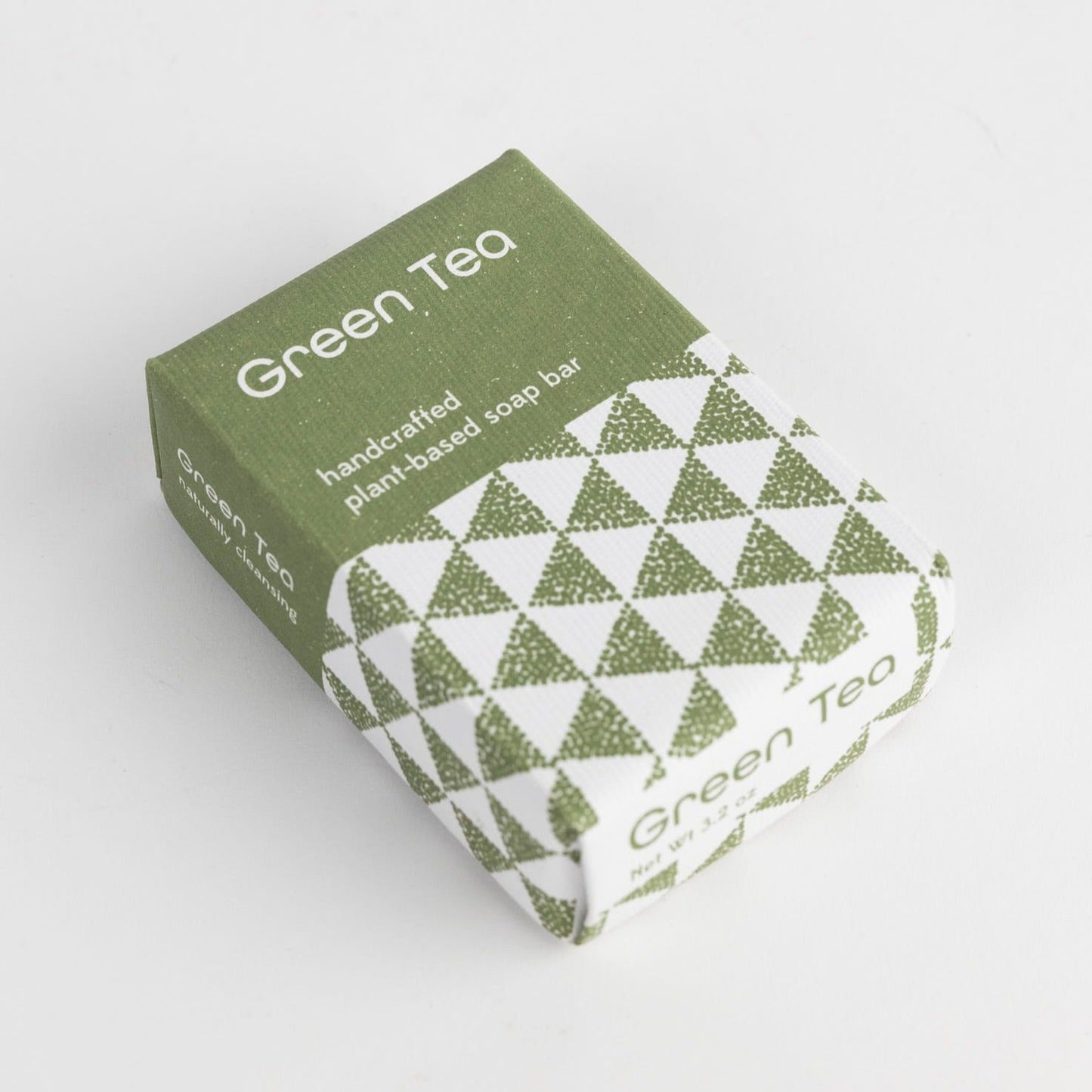 A green and white rectangular soap package is styled on a plain white background.