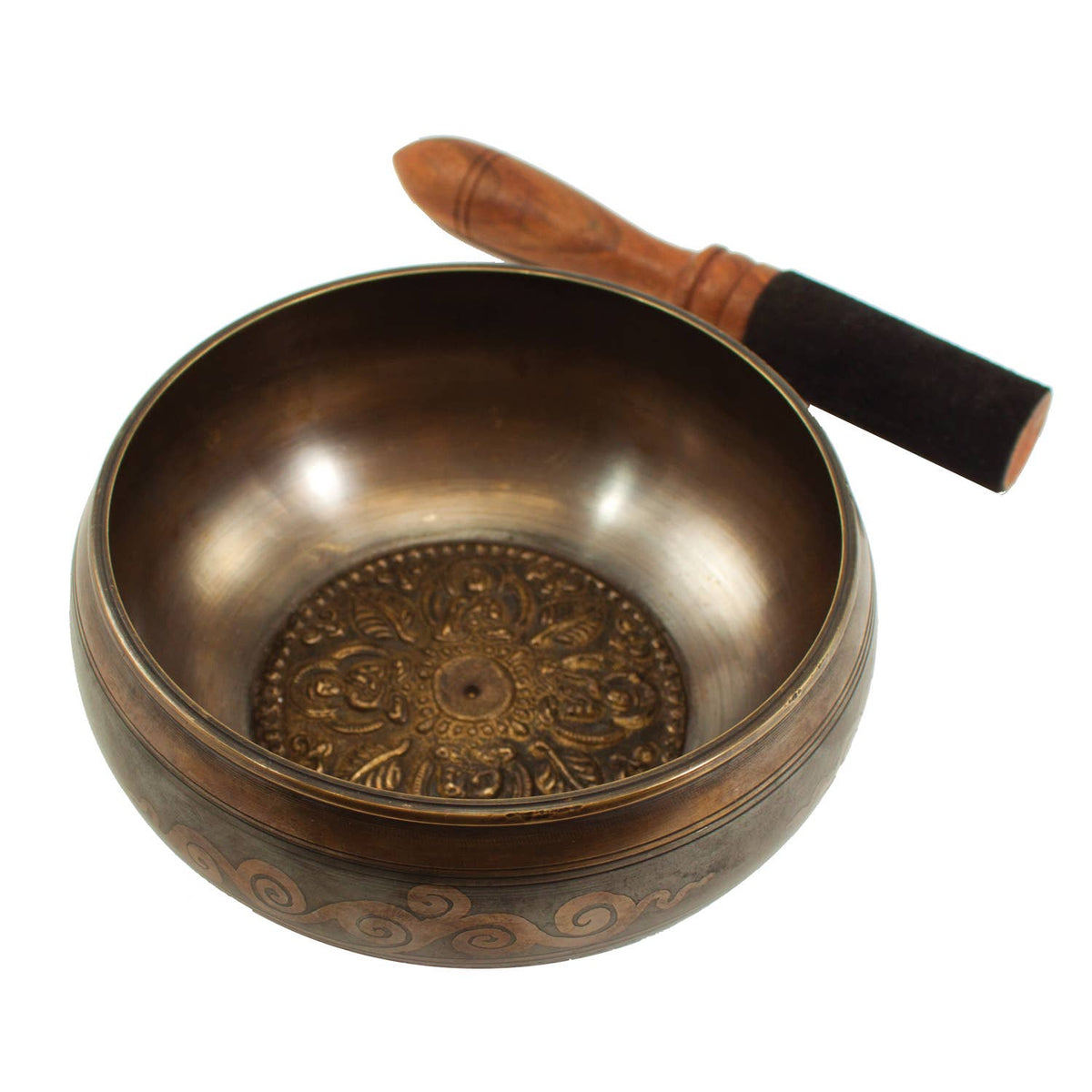 Bronze singing bowl with decorative patterns and a wooden handle on a white background