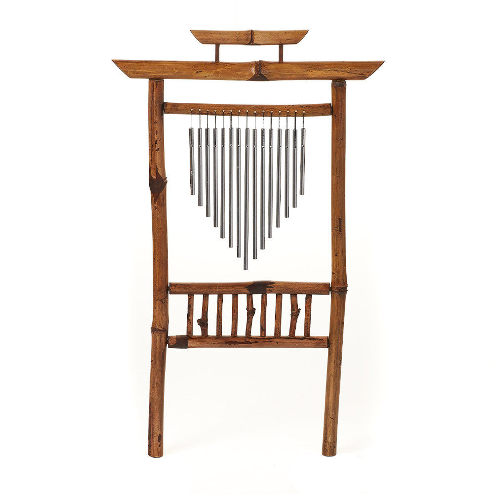 Wooden wind chime with metal hanging components on a white background
