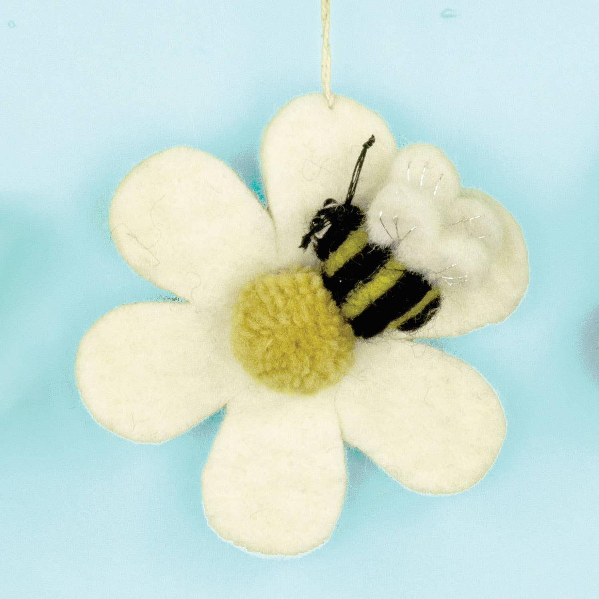 Floral ornament with a bee on a light blue background