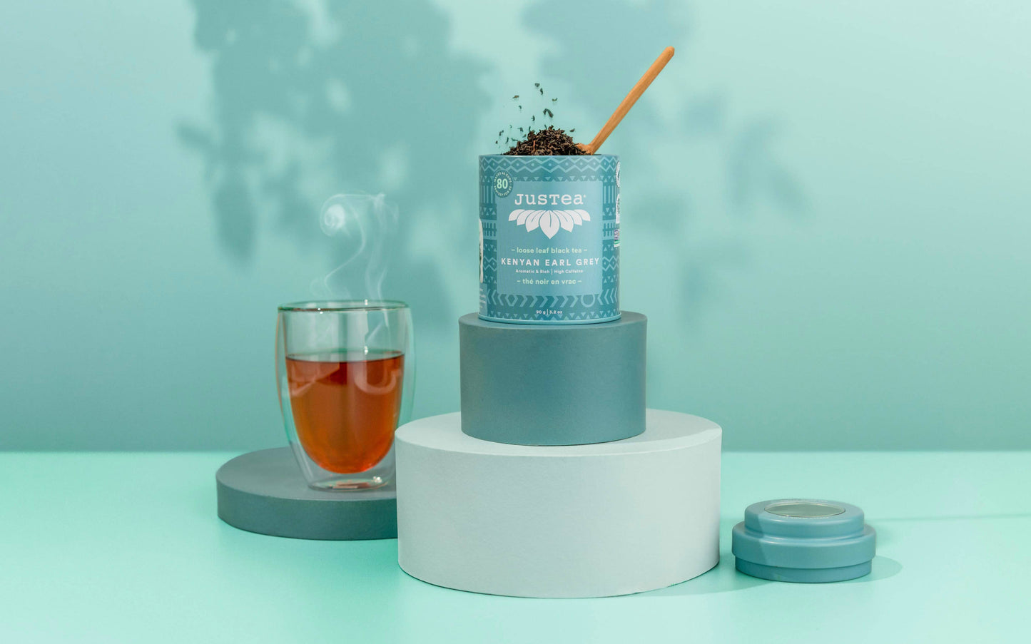 Tea packaging with a glass of tea on a light blue background