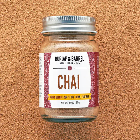 Jar of Burlap & Barrel Chai spice blend on a textured brown background