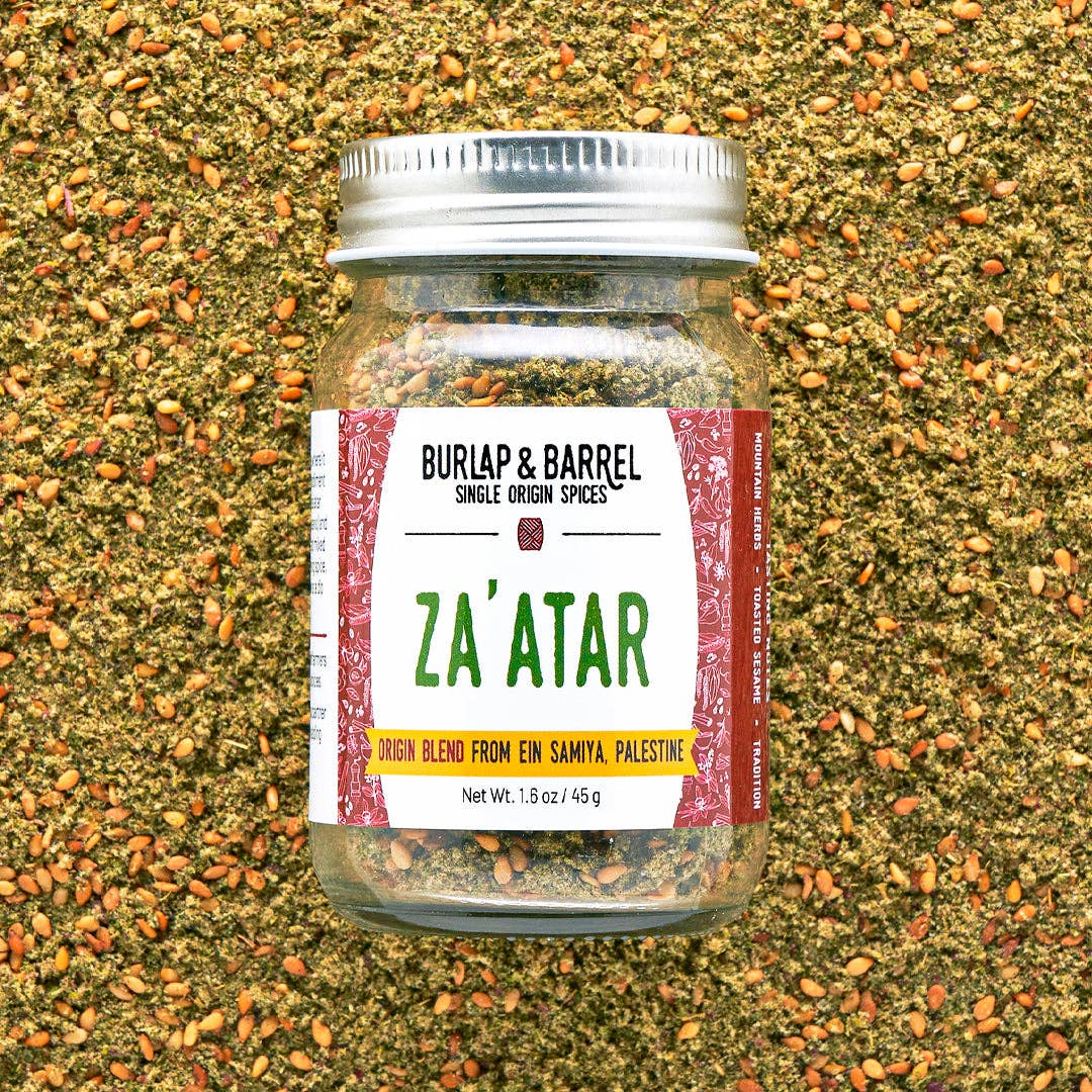 Jar of Za'atar spice blend from Burlap & Barrel on a textured spice background
