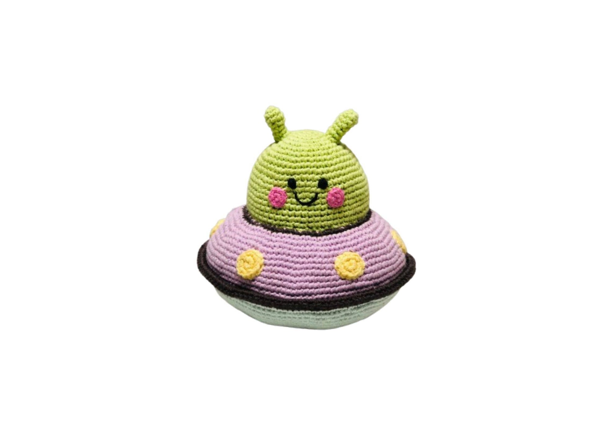Crocheted alien toy with a smiling face on a white background