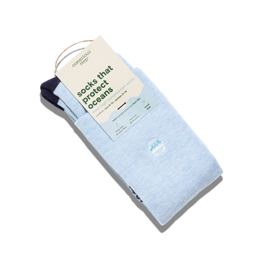 Pack of light blue socks with a tag indicating 'socks that protect oceans' on a white background